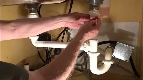 sink drain repair in Burlington kitchen with modern countertop and clean plumbing area